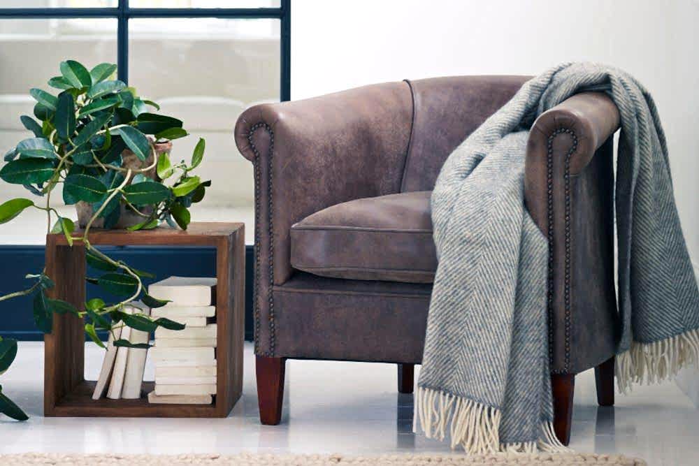 Self care with house plants, stylish storage cube and tub chair